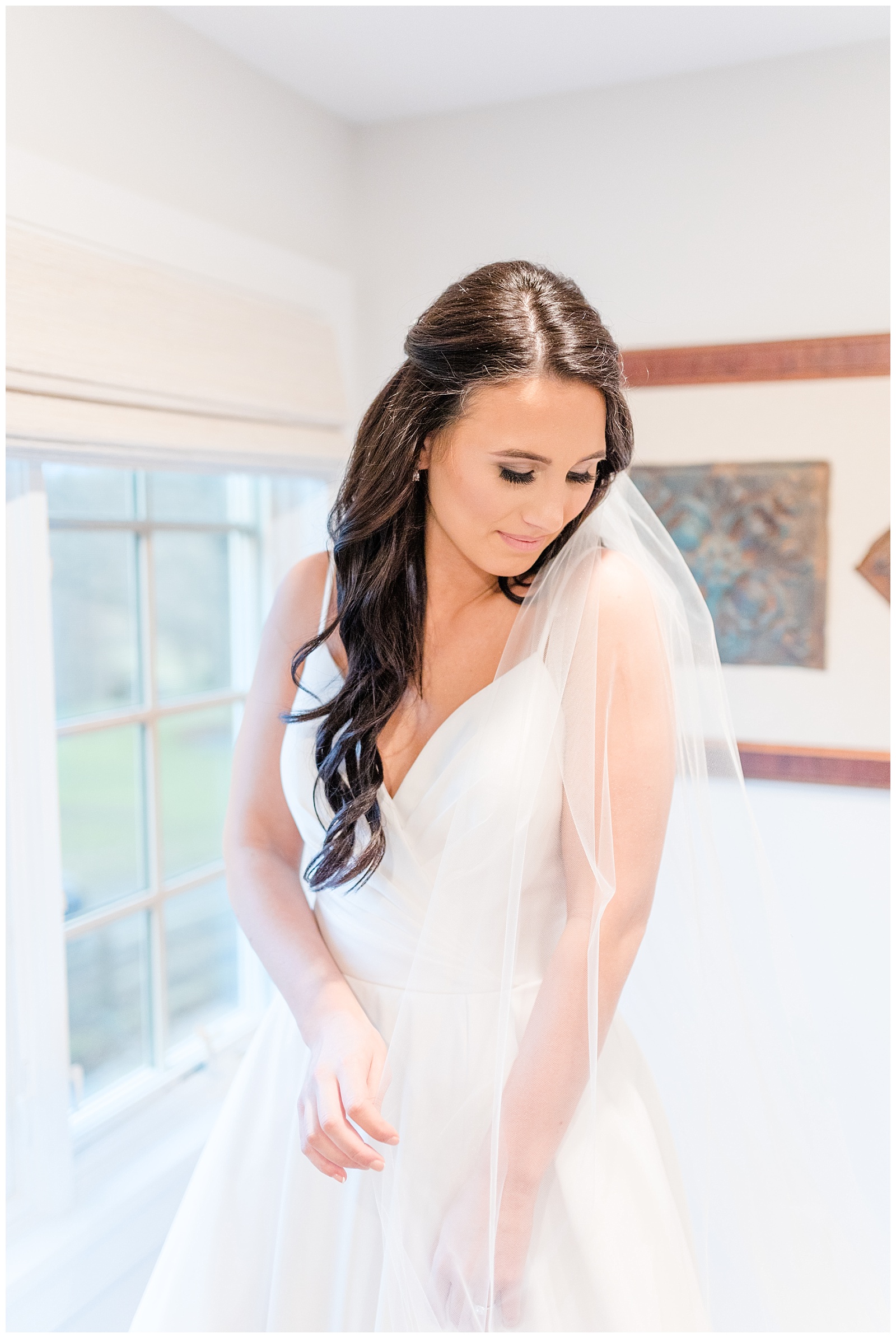 bride rustles with her long tulle veil
