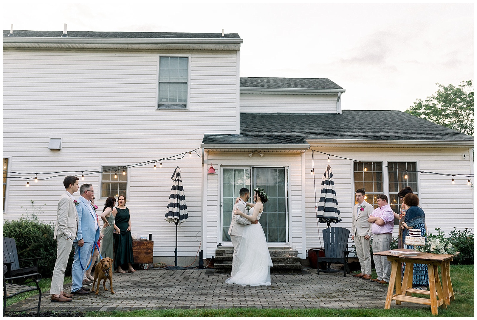 couple shares first dance on their own back patio at intimate home wedding in pa