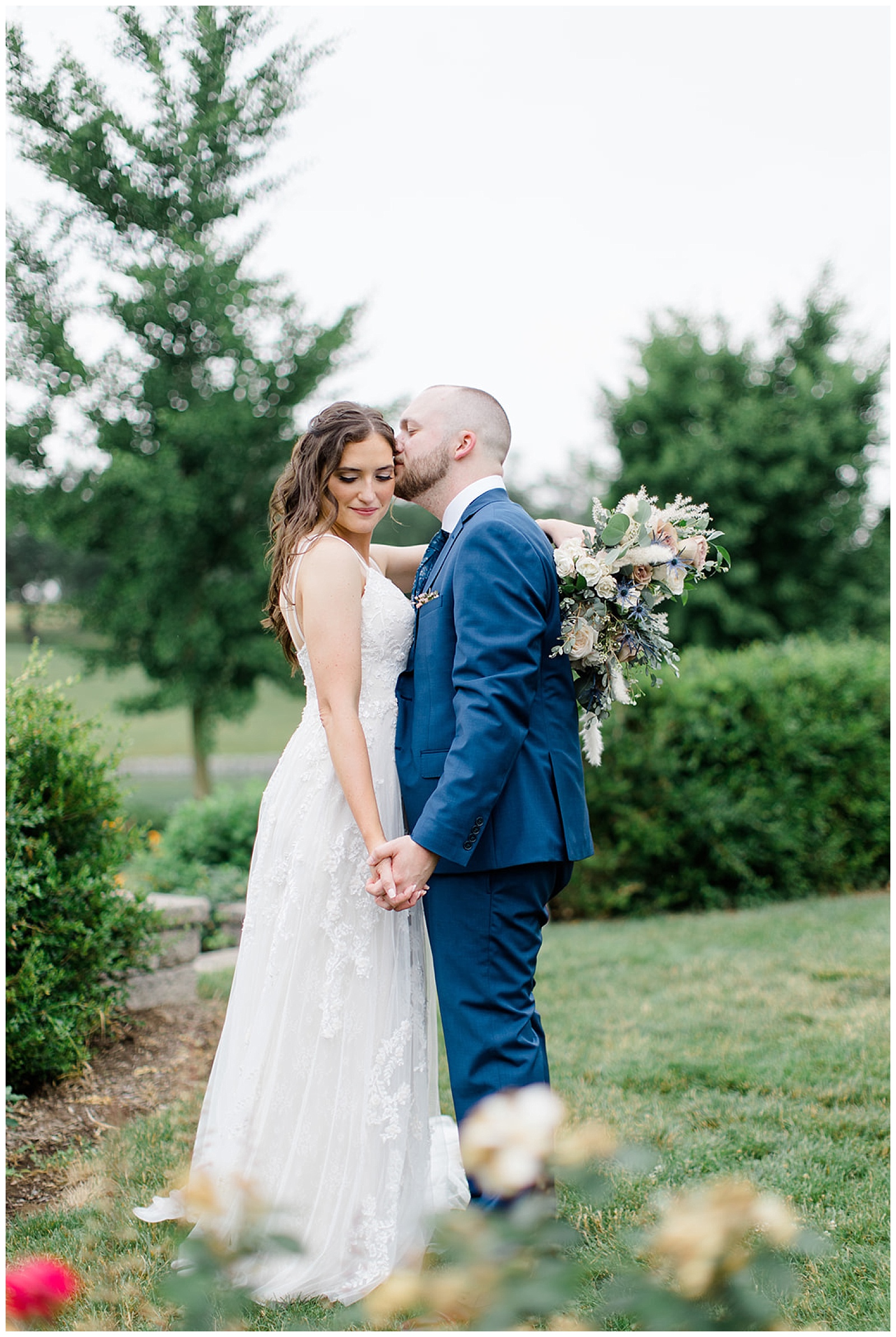 couple takes wedding portraits at lakefield weddings, a modern barn wedding venue