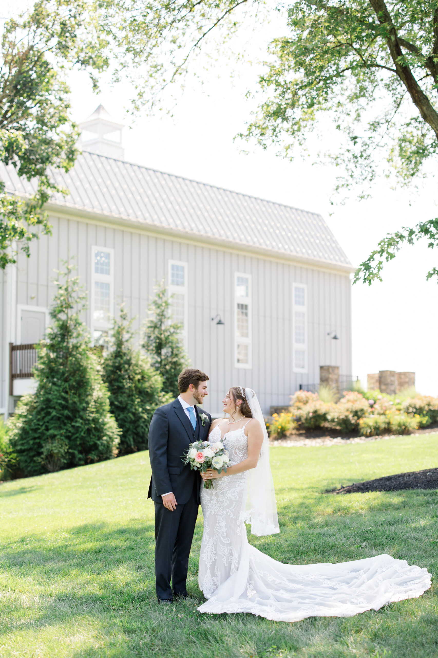 A couple looking into each others eyes in front of the chapel at Rosewood Weddings.